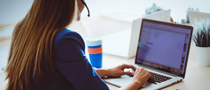A woman on a meeting in front of her laptop