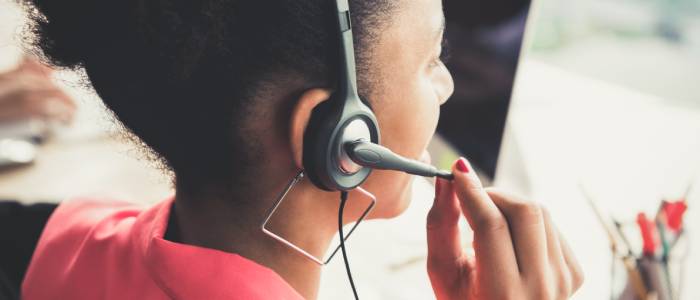 A woman on a phone with an headset