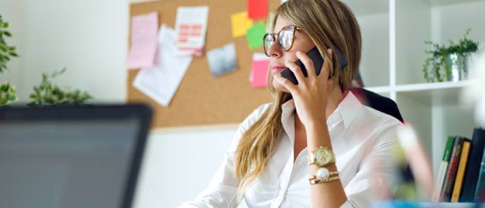 A woman on a phone in her desk
