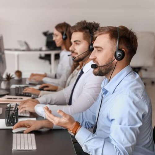 Many agents with headsets at screens