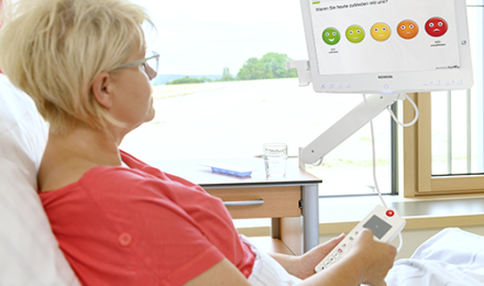 Woman in hospital bed with HiMed Screen